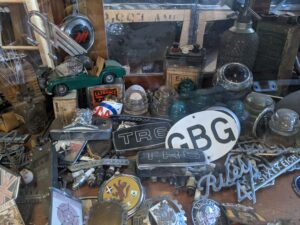 Showcases below the counter where Ed Tretwold has sold parts for the past 51 years are loaded with emblems, badges, trim pieces and memorabilia